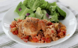 arroz con pollo and salad on a plate