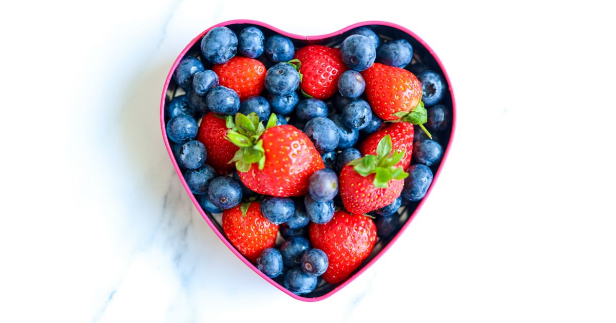 Heart shaped bowl filled with heart healthy berries