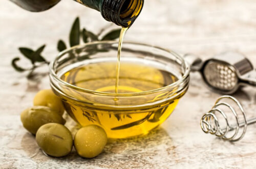 Pouring a bottle of heart healthy olive oil