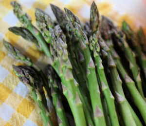 A bunch of fresh green asparagus on checkered cloth