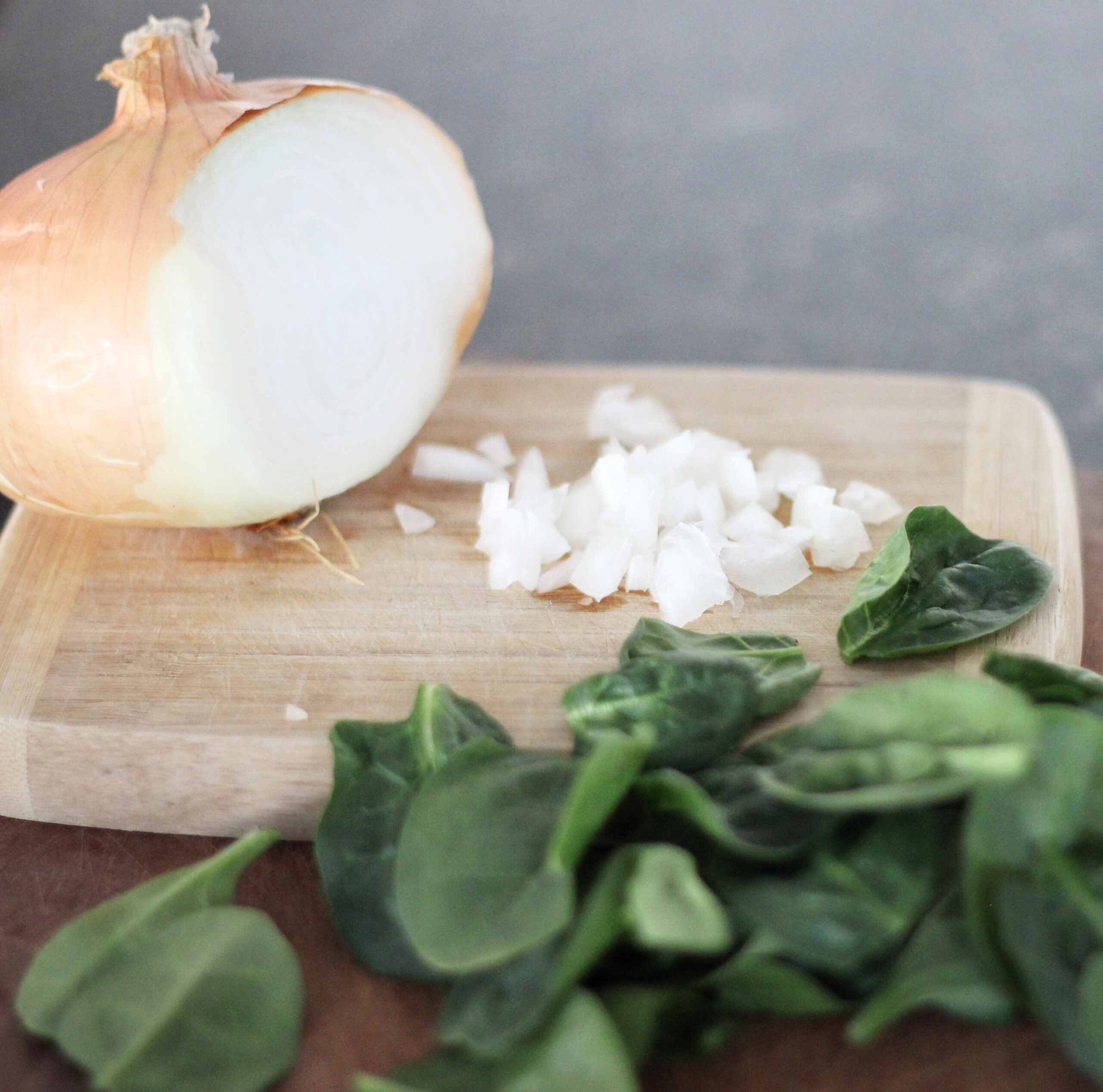 chopped onion and fresh spinach