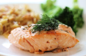 Grilled salmon with lemon and dill on a plate