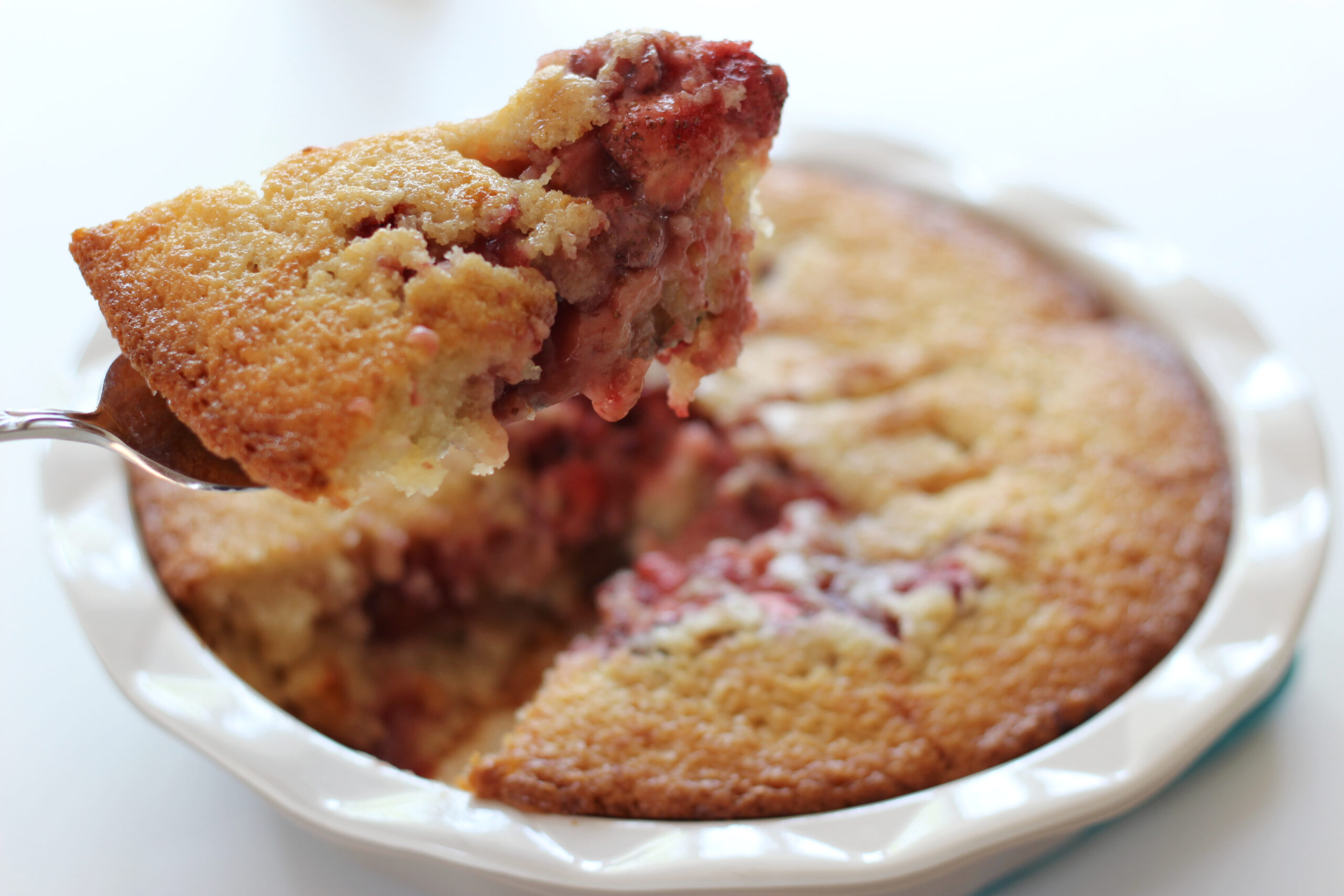 Strawberry cobbler being sliced